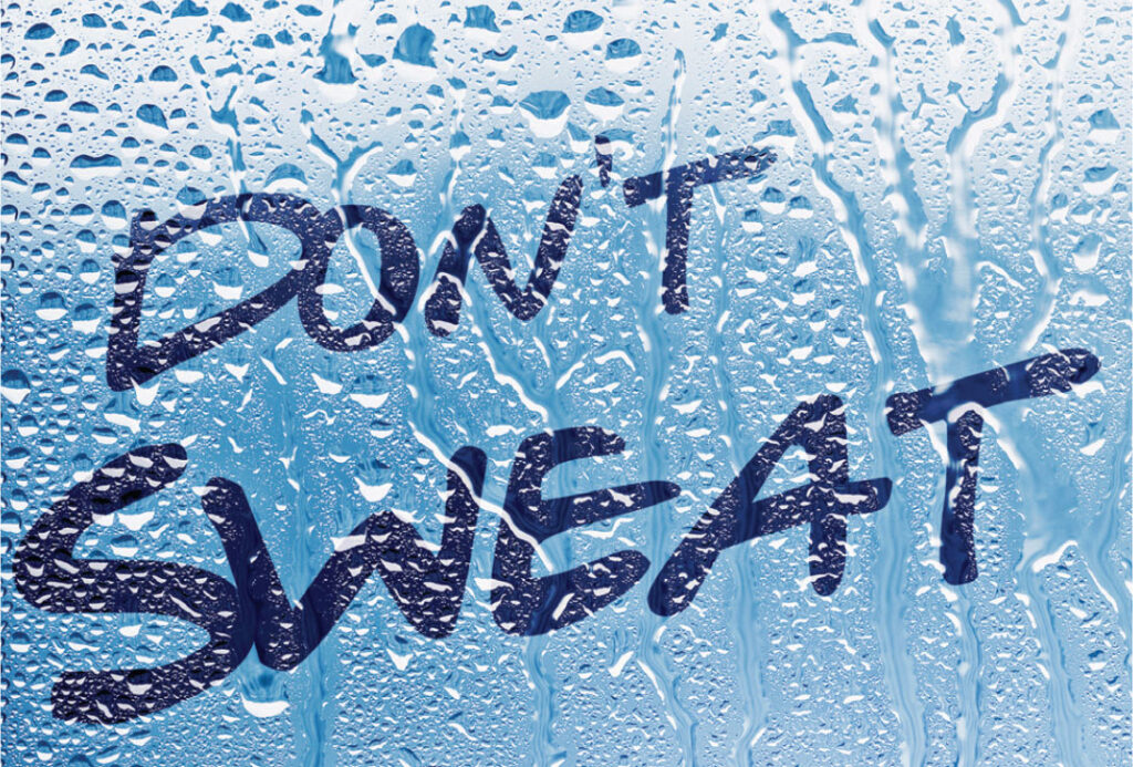 The words “Don’t Sweat It” on a blue surface covered in water droplets.