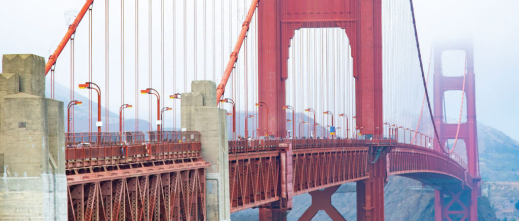 View along the Golden Gate Bridge with its red towers and suspension cables.