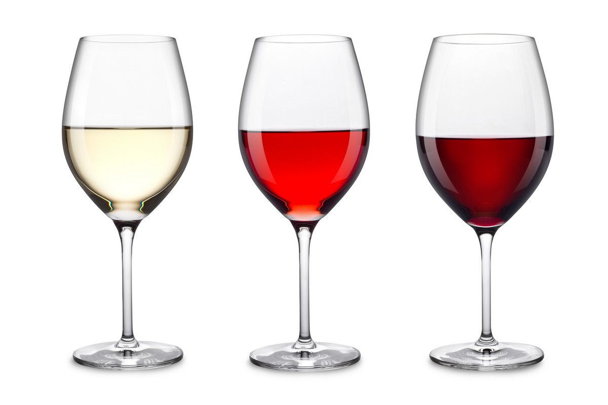 Three stemmed glasses containing white, rosé and red wine.