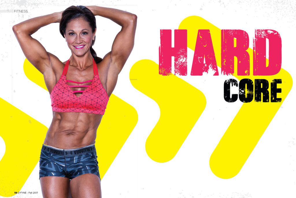 Woman in a pink sports bra posing with hands behind her head beside the heading Hard Core.