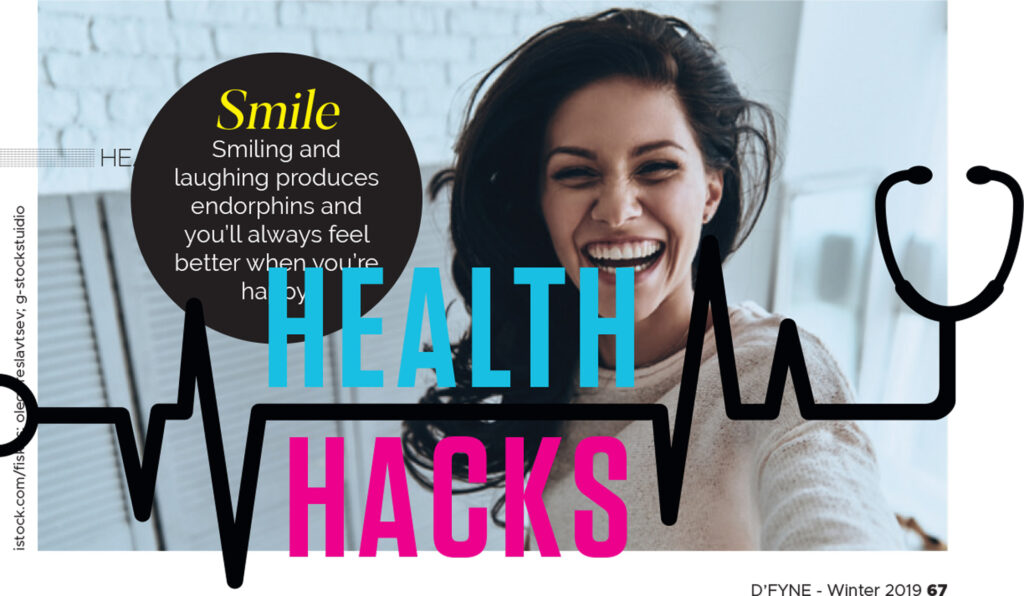 Smiling woman with dark hair in a light room, overlaid with text about smiling producing endorphins and the words Health Hacks with a heartbeat line and stethoscope graphic.