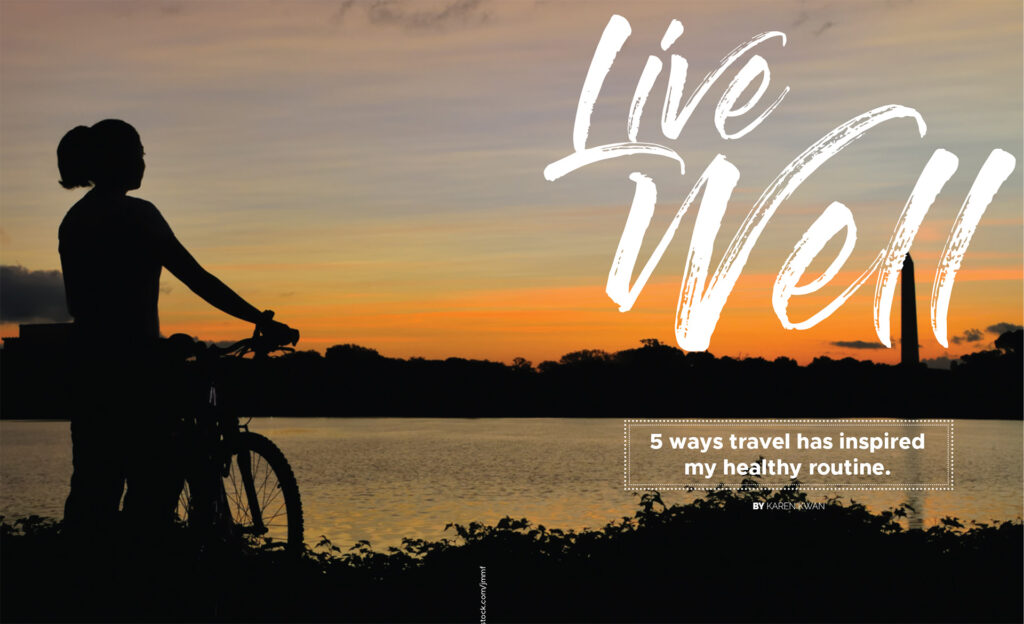 Cyclist silhouetted beside water at sunset with “Live Well: 5 ways travel has inspired my healthy routine”.