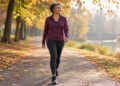 Midlife woman beginning an easy walk on a level autumn park path